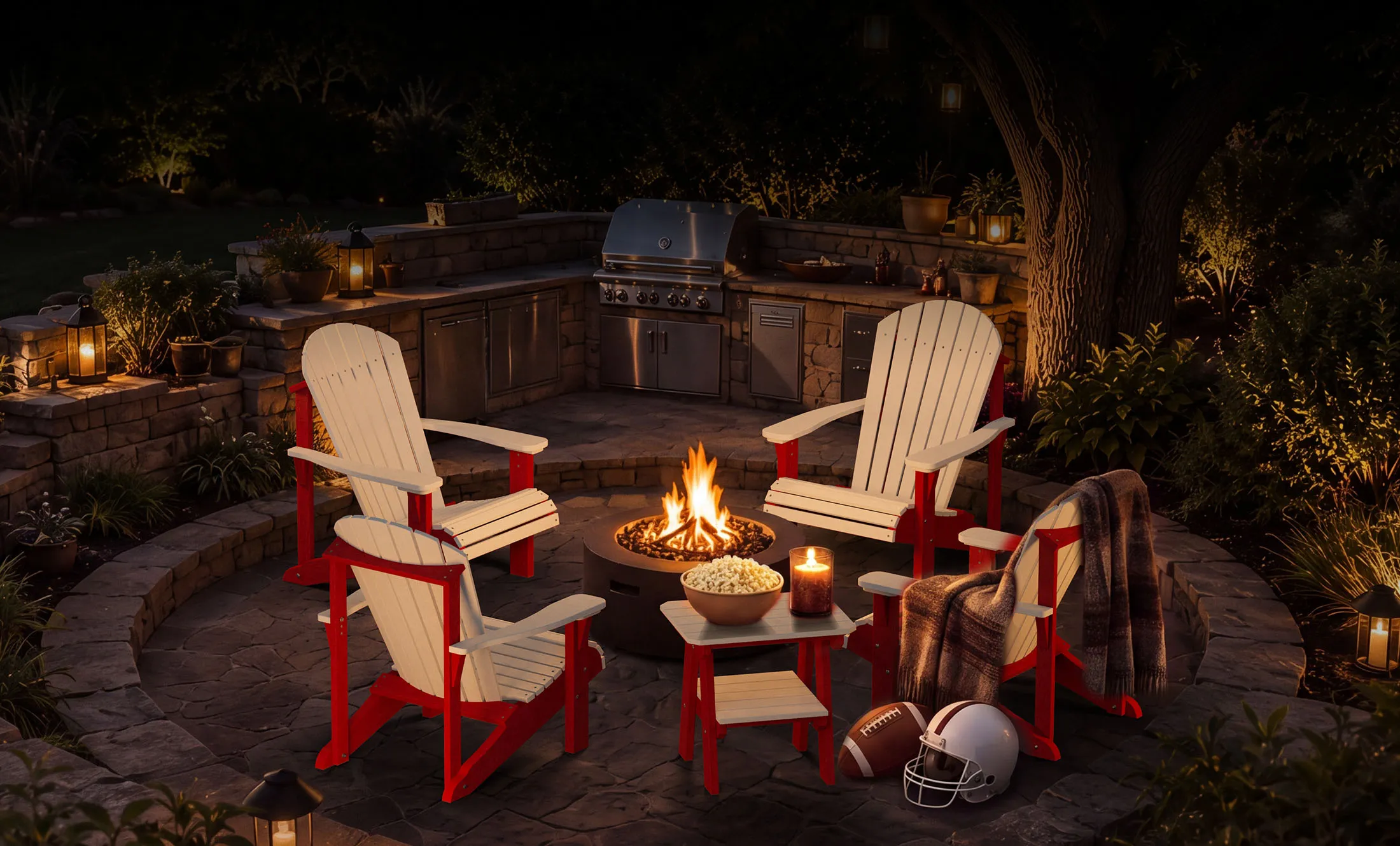Red and cream Wildridge Adirondack chairs gathered around a lit fire pit on a backyard patio at night with football gear nearby